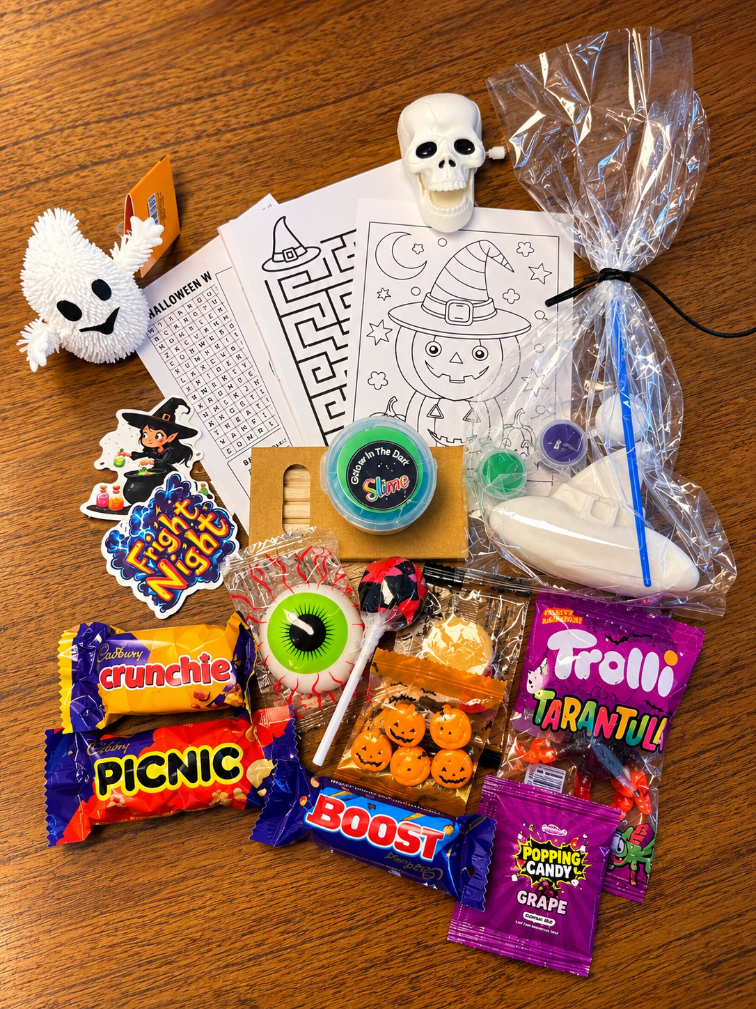 Halloween bag contents including activities, toys, slime, chocolate and lollies